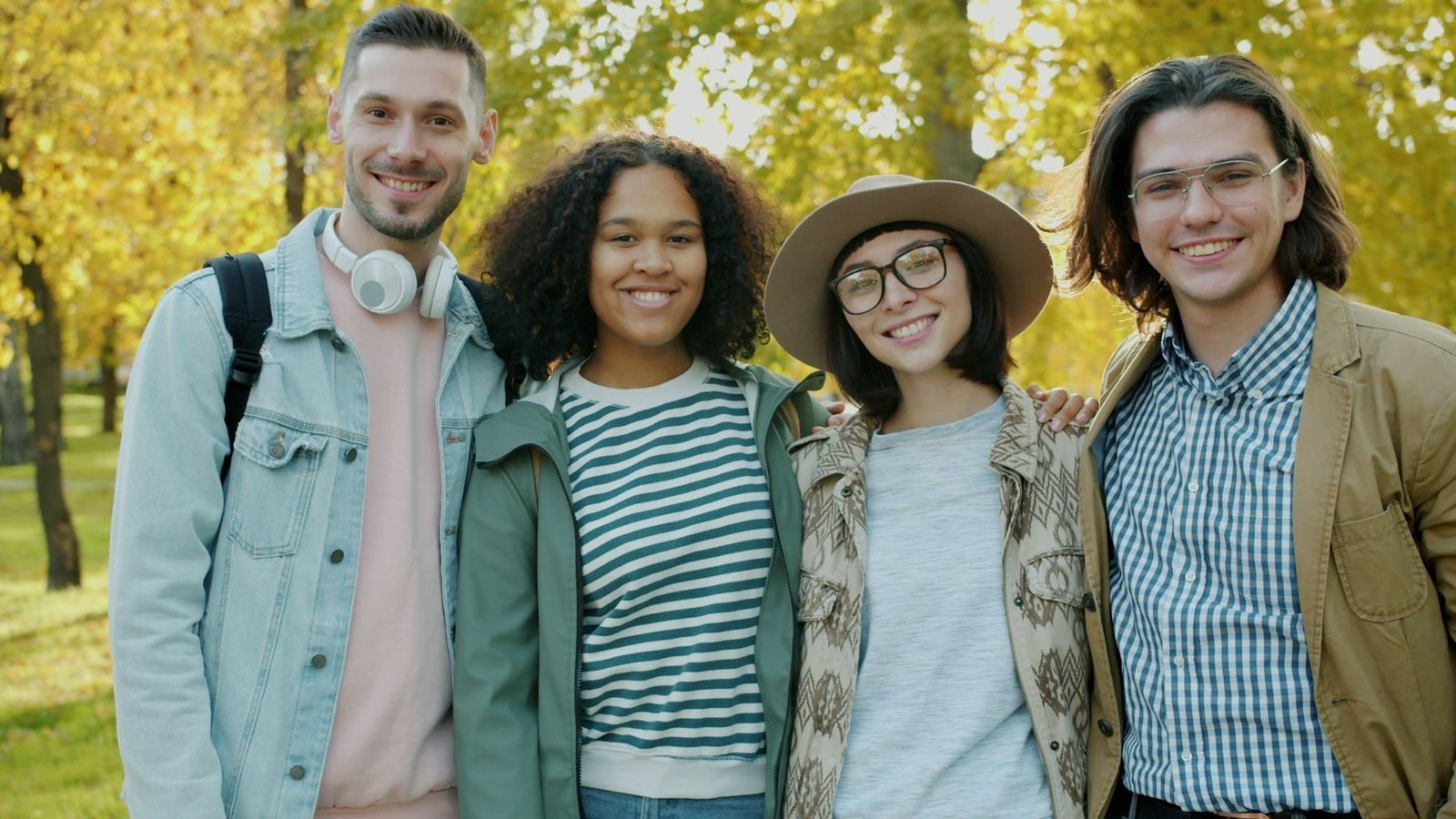 Friends smiling in a park in autumn
