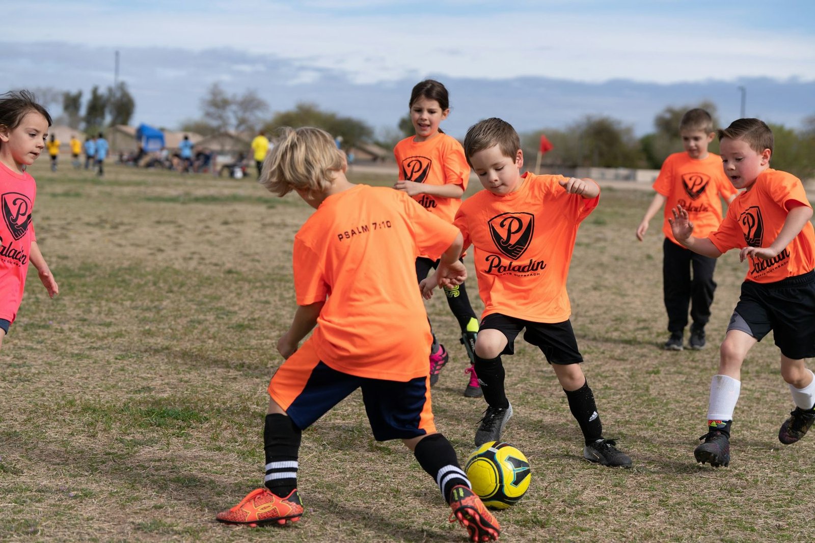 Children playing soccer together