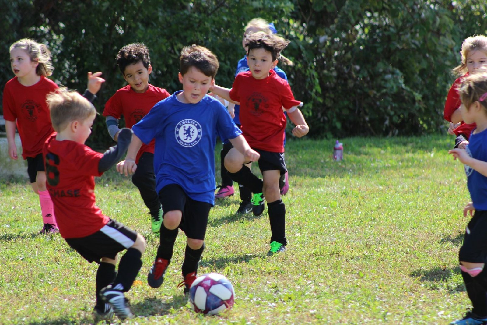 A young player kicking a soccer ball